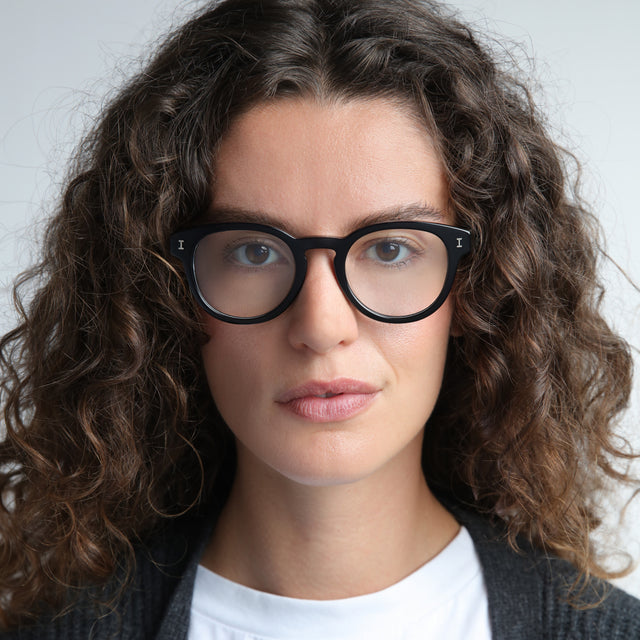 Woman in a gray cardigan wearing The Met x illesteva II Optical Black Optical