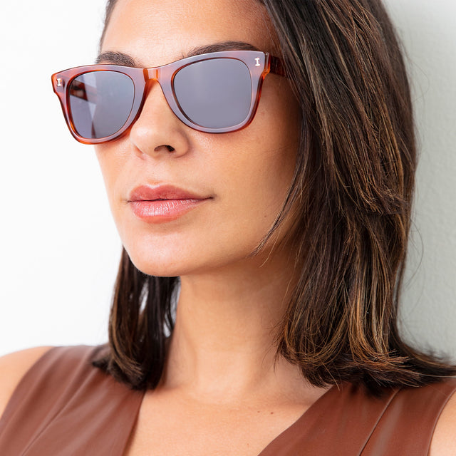 Brunette model with shoulder-length hair wearing Austin Sunglasses Red Havana with Grey Flat