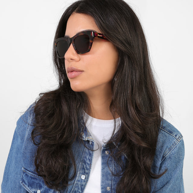 Brunette model in a denim jacket looking right wearing Bali Sunglasses Havana with Brown