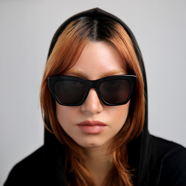 Another angle of red-haired model wearing Bali Sunglasses Black with Grey