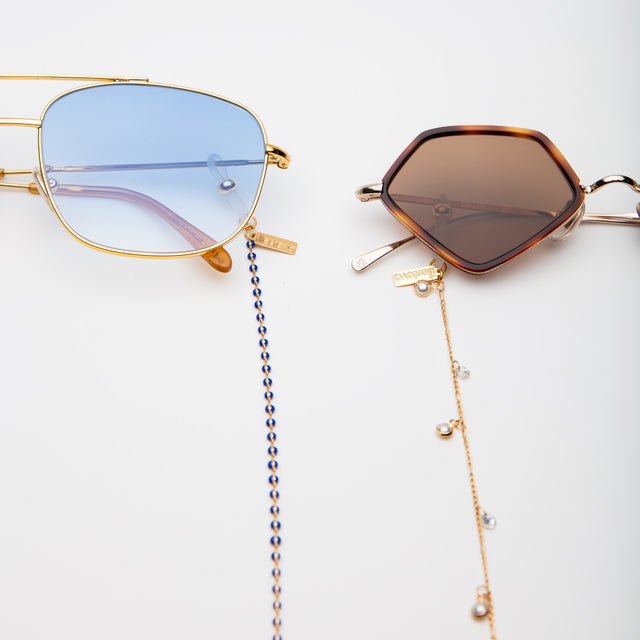 The Frankie Sunglasses with the sunglass chain attached next to another frame with Margarita attached  Barbados