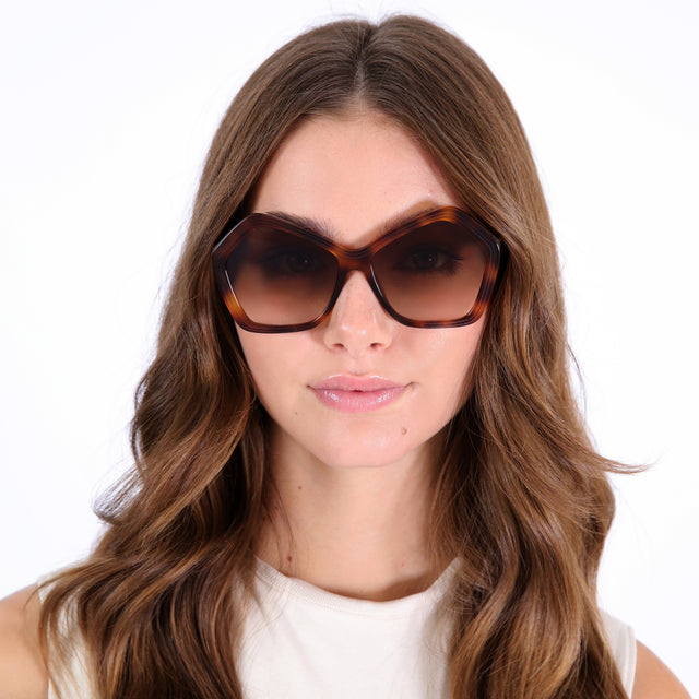 Brunette model with curled hair wearing Barbra 55 Sunglasses Havana with Brown Flat Gradient