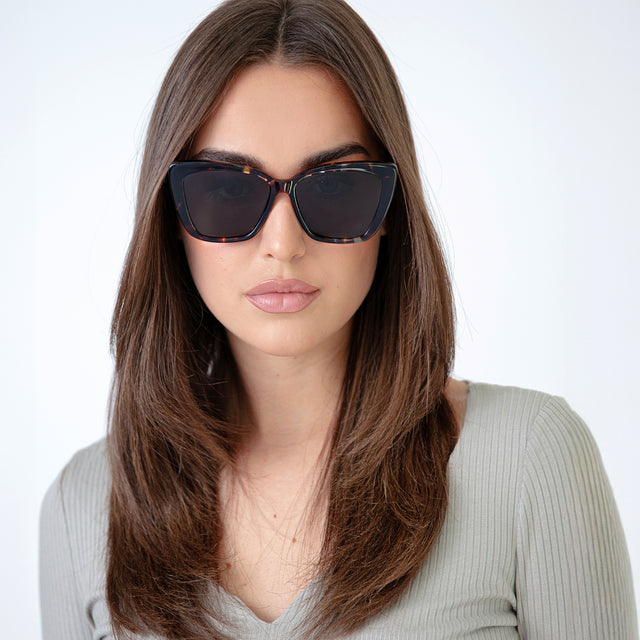 Brunette woman with straight hair wearing Barcelona Sunglasses Sea Glass with Grey Flat