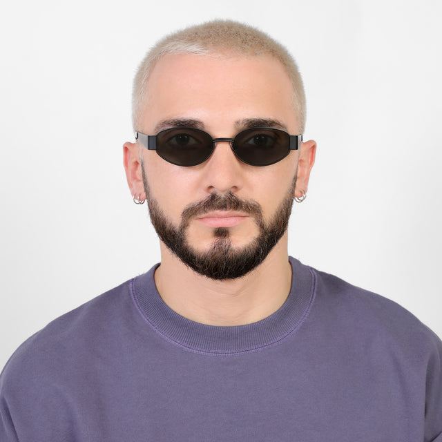 Model with a platinum buzzcut wearing Bellagio Sunglasses Matte Black with Grey