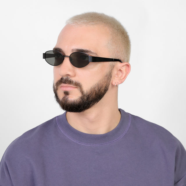 Bearded model looking right wearing Bellagio Sunglasses Matte Black with Grey