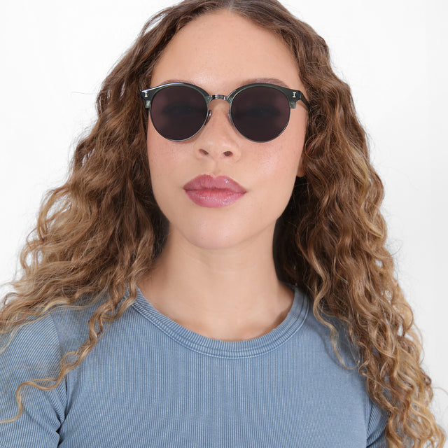 Brunette model with ombré, natural curls wearing Benson Sunglasses Pine/Gunmetal with Grey