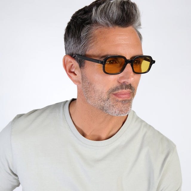 Male model looking left wearing Berlin Sunglasses Shadow with Honey See Through