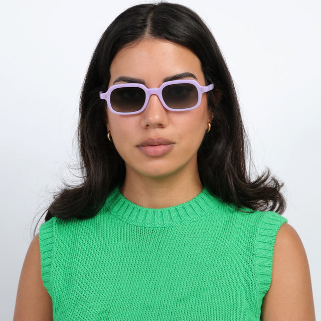 Brunette model with loose curls wearing Berlin Sunglasses Matte Lilac with Olive Gradient