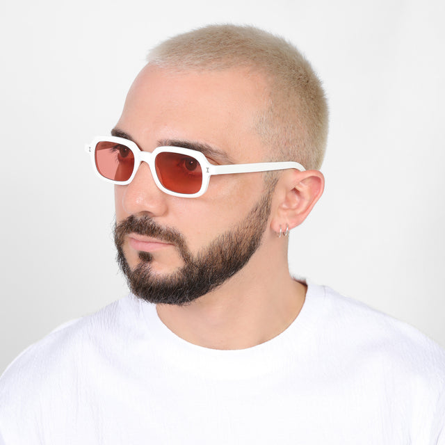 Bearded model looking right wearing Berlin Sunglasses White with Guava See Through