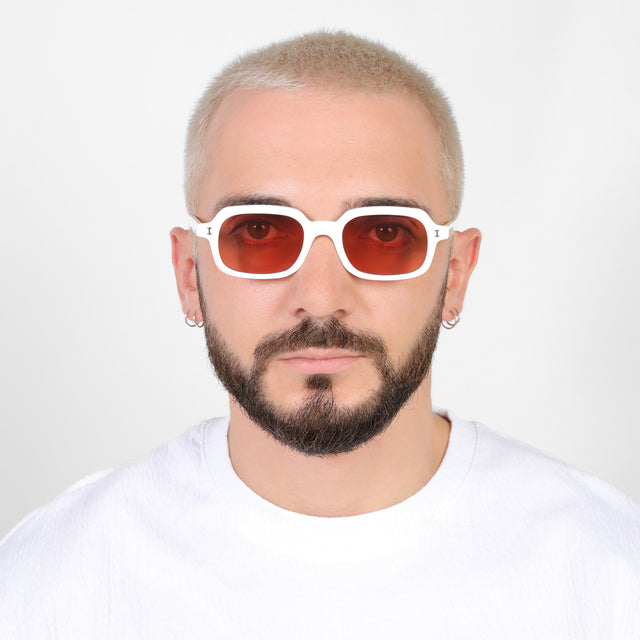 Model with a platinum buzzcut wearing Berlin Sunglasses White with Guava See Through