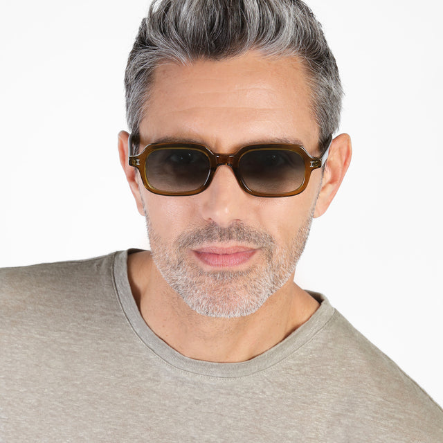 Model with salt and pepper hair and beard wearing Berlin Sunglasses Moss with Olive Gradient