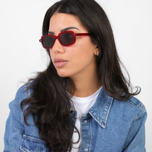 Brunette model in a denim jacket looking right wearing Berlin Sunglasses Mulberry with Grey