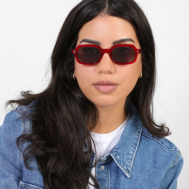 Brunette model in a denim jacket wearing Berlin Sunglasses Mulberry with Grey