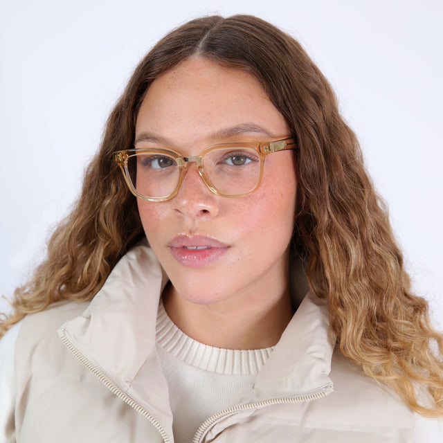 Brunette model with ombré, curled hair wearing Bobby Optical Citrine/Gold Optical