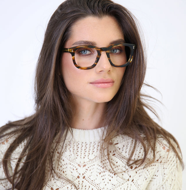 Brunette model with straight hair wearing Boston Optical Dark Sand Optical