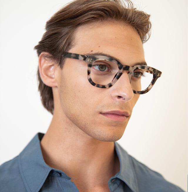 Model with pushed back hair wearing Boston Optical White Tortoise Optical