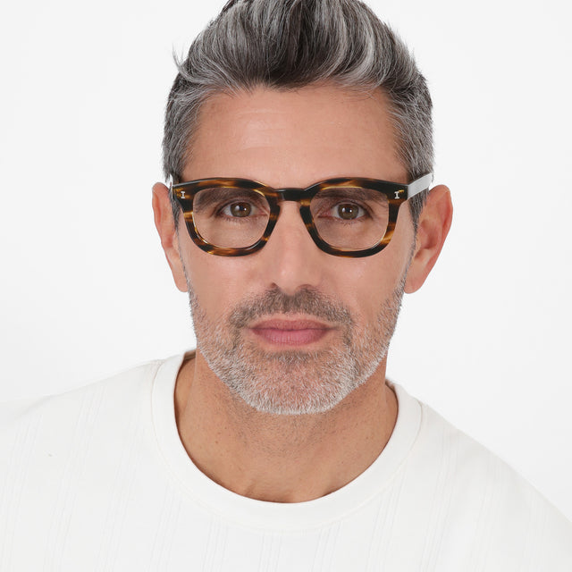 Model with salt and pepper hair and beard wearing Boston Optical Dark Sand Optical