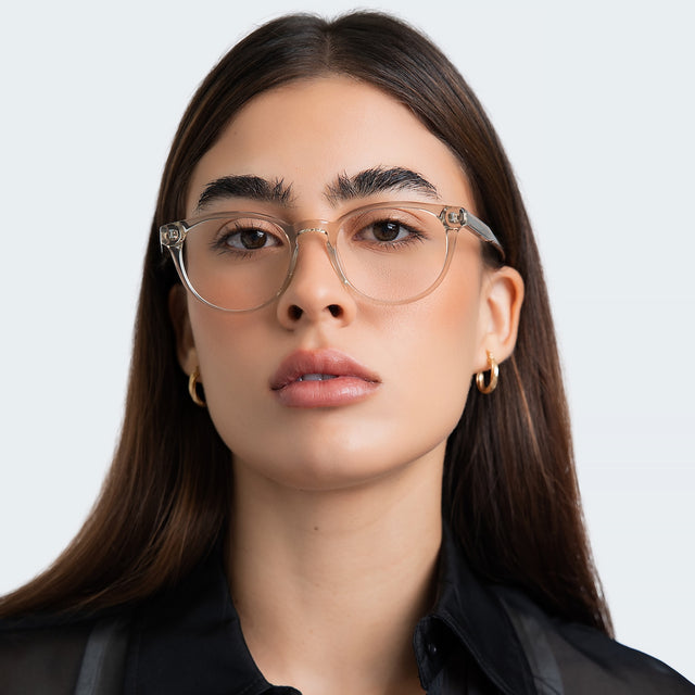 Close up of woman in a sheer black blouse wearing Bristol Optical Cool Grey Optical