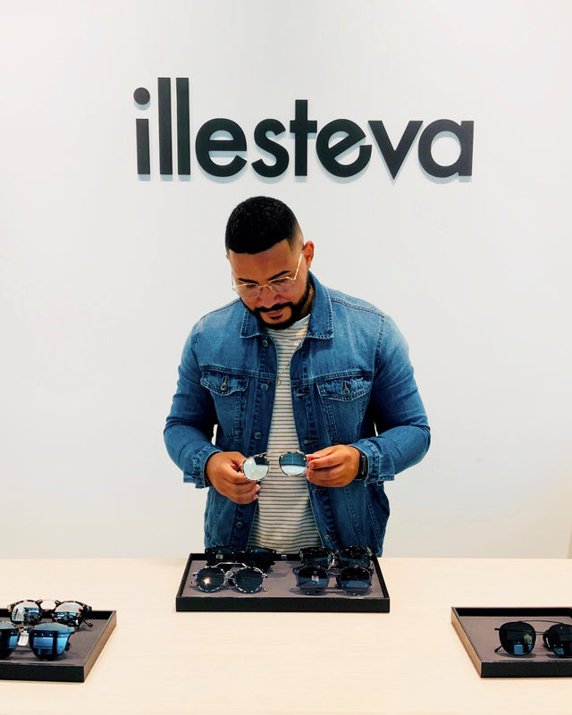 Store manager showcasing a stylish pair of Illesteva sunglasses