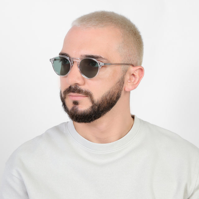 Bearded model looking right wearing Capri Sunglasses Clear with Olive