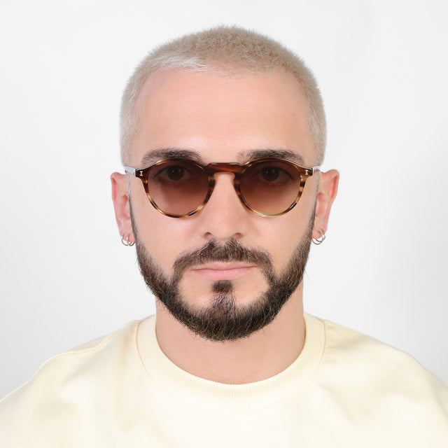 Model with platinum buzzcut wearing Capri Sunglasses Sand Dune with Brown Gradient