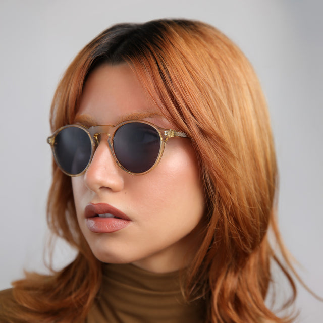 Another angle of model with red hair wearing Capri Sunglasses Citrine with Grey