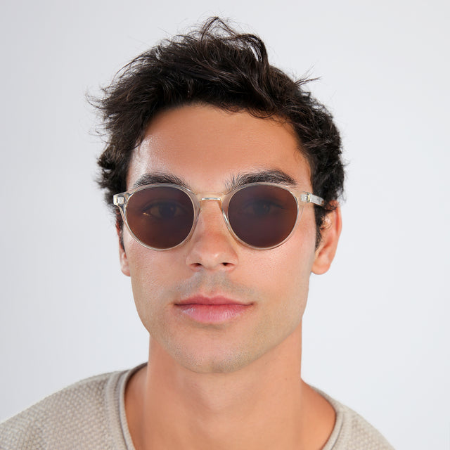 Another angle of man in a beige waffled sweatshirt wearing Como Sunglasses Champagne with Brown