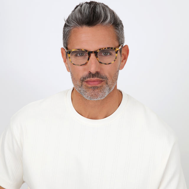 Model with salt and pepper hair and beard wearing Copenhagen Optical Tortoise Optical