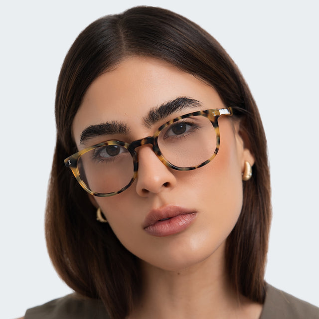 Woman in a taupe blouse wearing Copenhagen Optical Tortoise Optical