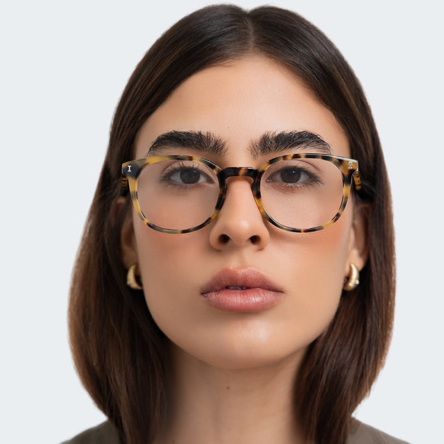 Another angle of woman in a taupe blouse wearing Copenhagen Optical Tortoise Optical