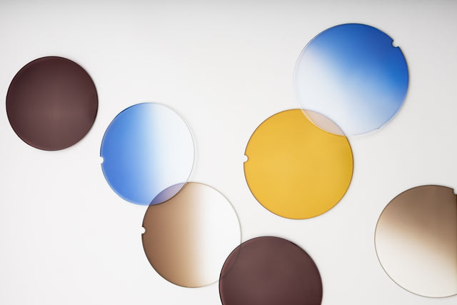 Set of round lens samples in various tints colors on a white background