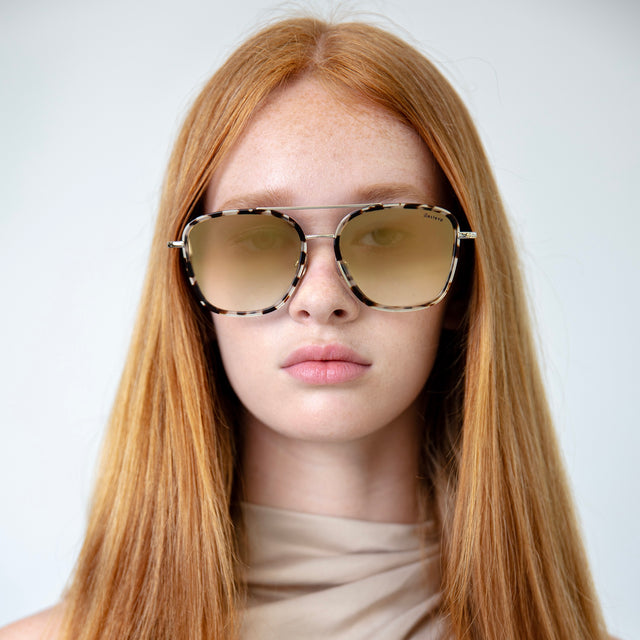 Model with straight red hair wearing Delos Ace Sunglasses White Tortoise/Gold with Gold Flat Mirror Gradient