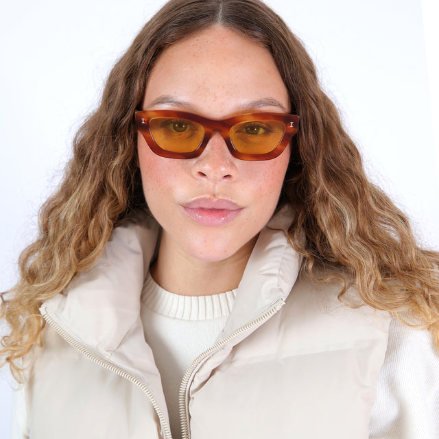 Brunette model with ombré curls wearing Donna Sunglasses Saffron Havana with Honey See Through