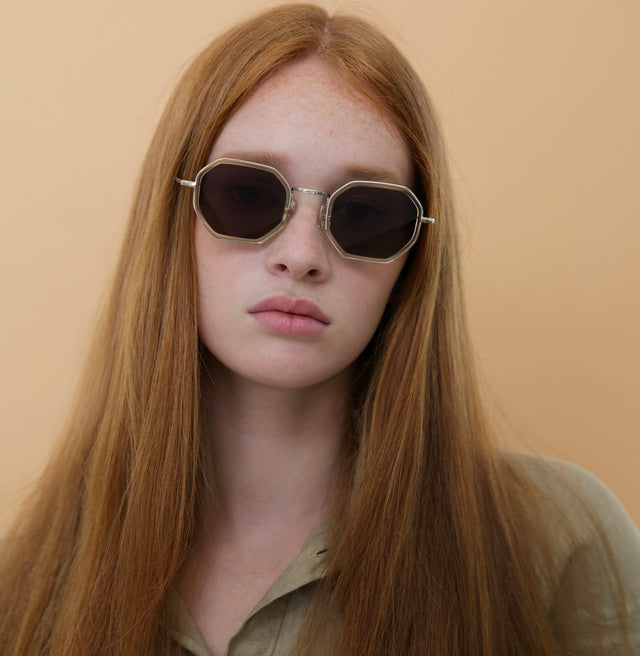 Model with red straight hair wearing Dylan Tate Sunglasses Champagne Silver with Brown Flat Lenses