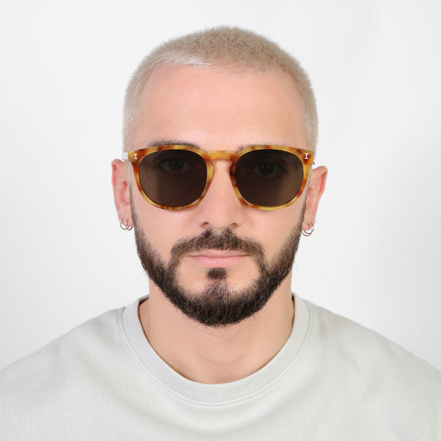 Model with platinum buzzcut wearing Eldridge 56 Sunglasses Amber with Olive Flat