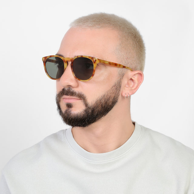 Bearded model looking right wearing Eldridge 56 Sunglasses Amber with Olive Flat