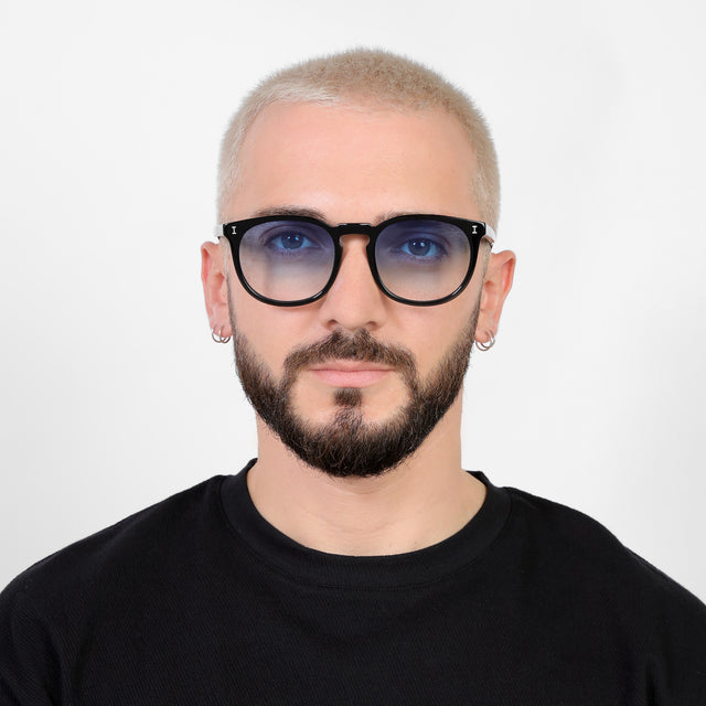 Model with platinum buzzcut wearing Eldridge 56 Sunglasses Black with Blue Flat Gradient See Through