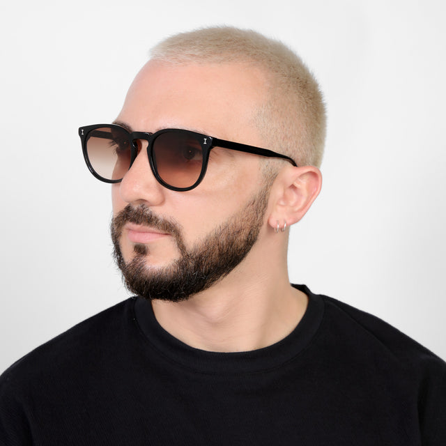 Bearded model looking right wearing Eldridge 56 Sunglasses Black with Brown Flat Gradient