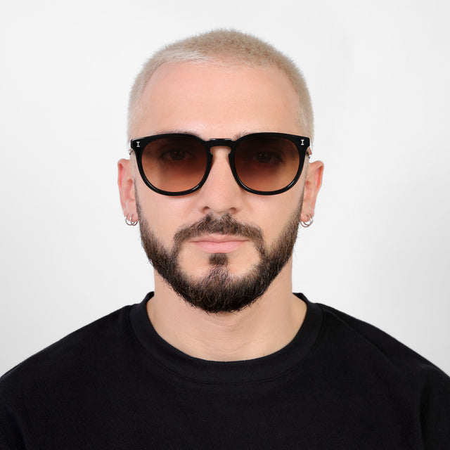 Model with platinum buzzcut wearing Eldridge 56 Sunglasses Black with Brown Flat Gradient