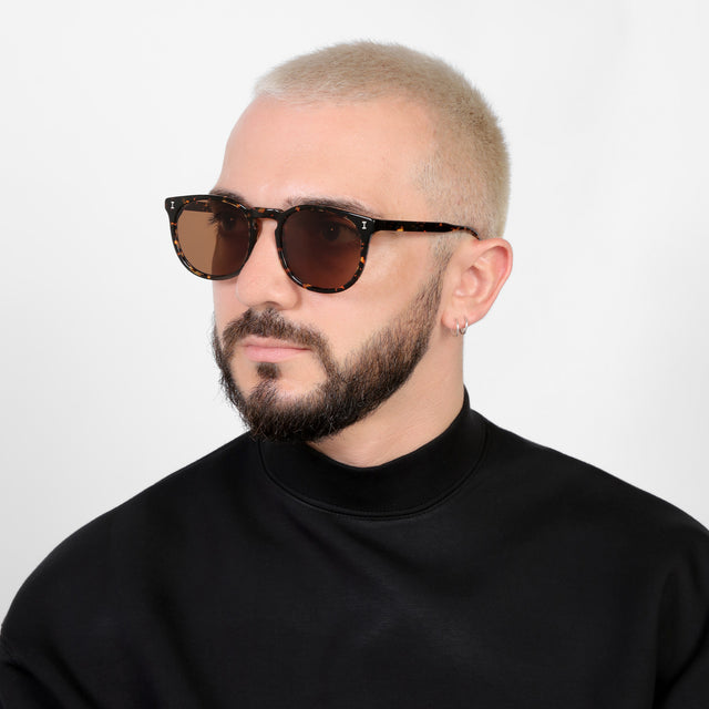 Bearded model looking right wearing Eldridge 56 Sunglasses Flame with Brown Flat