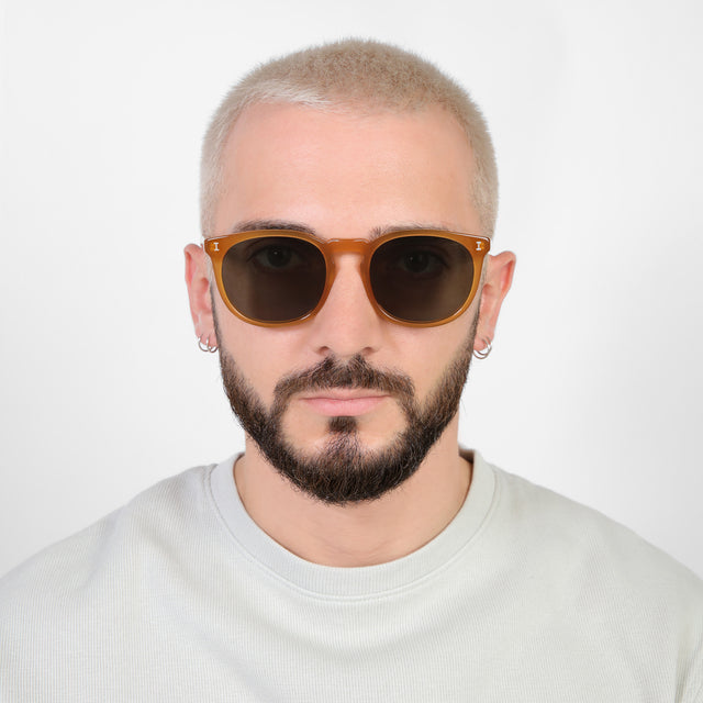 Model with platinum buzzcut wearing Eldridge 56 Sunglasses Honey with Olive Flat