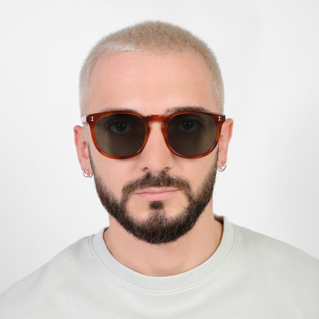 Model with platinum buzzcut wearing Eldridge 56 Sunglasses Red Havana with Olive Flat