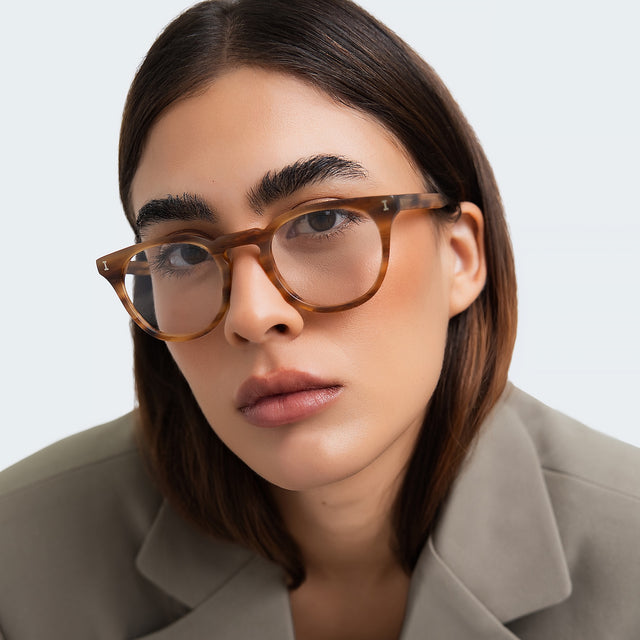 Close up of woman in a gray blazer wearing Eldridge 48 Optical Teak Optical
