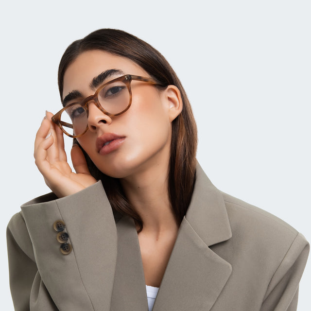 Woman in a gray blazer wearing Eldridge 48 Optical Teak Optical