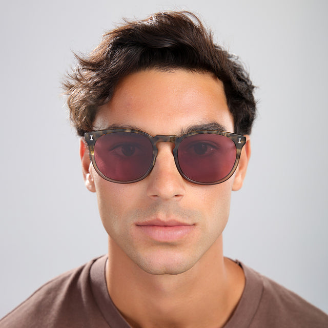 Man in a brown tee wearing Eldridge 56 Sunglasses Kale with Plum Flat See Through