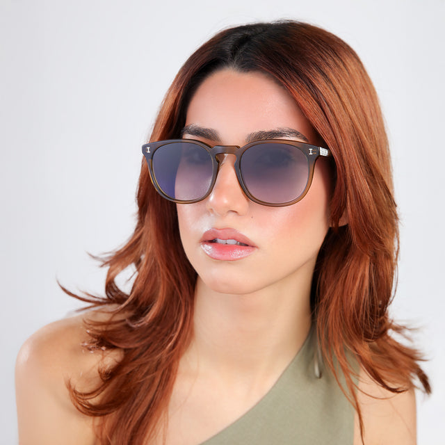 Another angle of woman with red hair in an olive blouse wearing Eldridge 56 Sunglasses Moss with Grey Flat Gradient