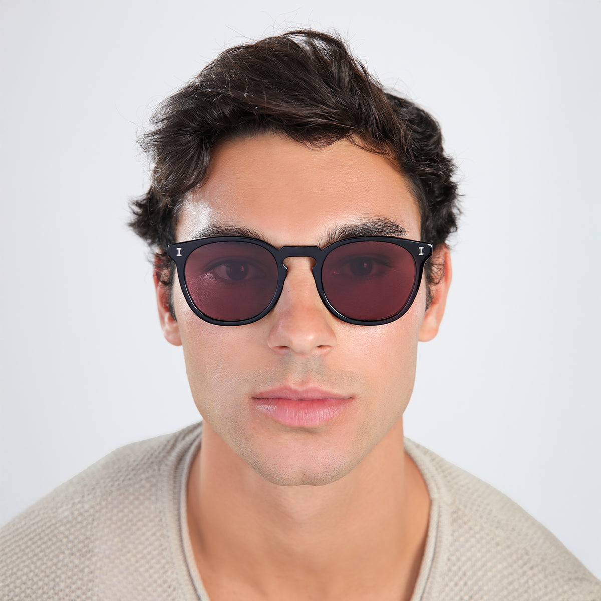 Man wearing Eldridge Sunglasses in Black with Plum Flat See Through lenses, front view, Another angle of man in a beige sweatshirt