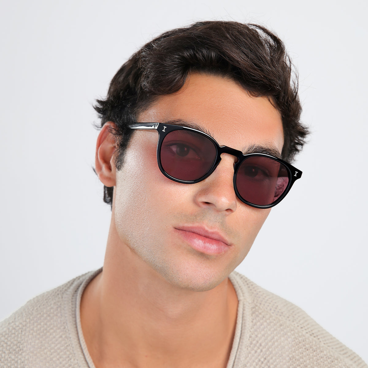 Man wearing Eldridge Sunglasses in Black with Plum Flat See Through lenses, side profile, Man in a beige waffled sweatshirt