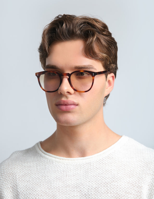 Man in a textured white shirt wearing the Eldridge in Havana with Taupe Flat Gradient