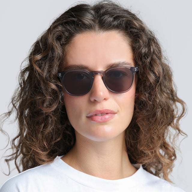 Woman in a white tee wearing Eldridge Sunglasses Mercury with Grey Flat